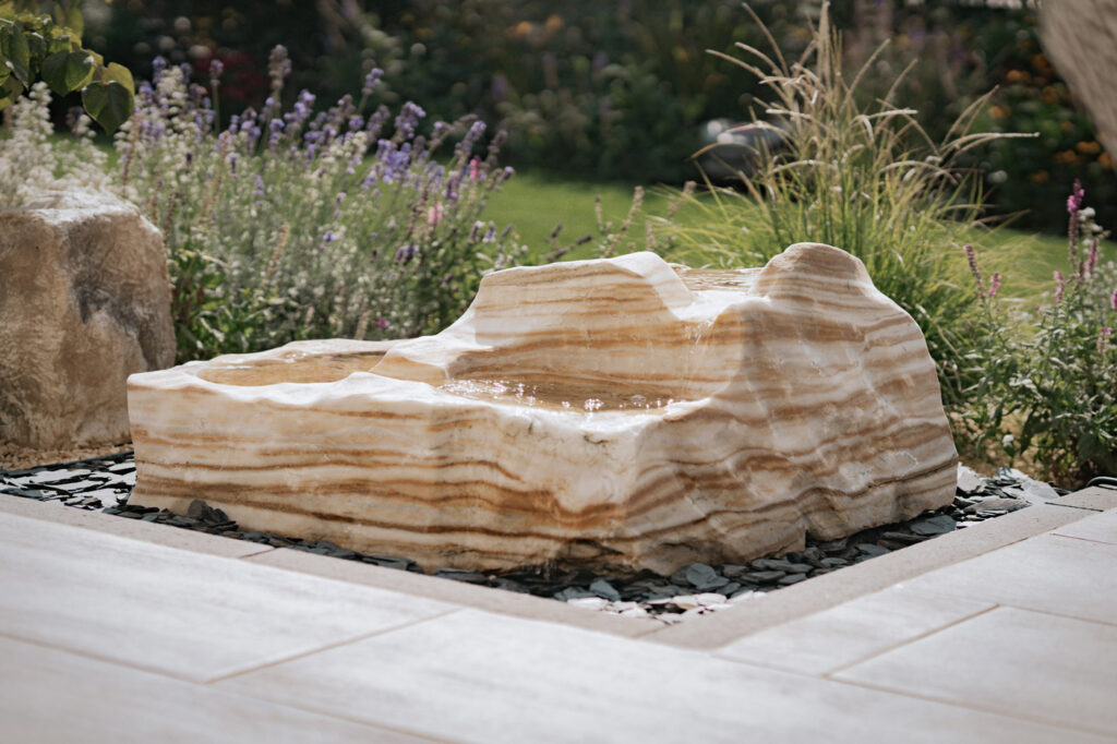 Seitz-Gartenbau - Wasser im Garten - Quellstein aus hellem, marmorierten Naturstein